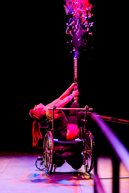 woman in a wheelchair performing onstage